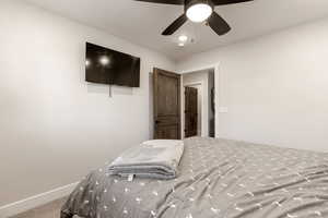 Bedroom with ceiling fan and carpet floors