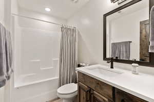 Full bathroom with shower / tub combo with curtain, vanity, and recessed lighting