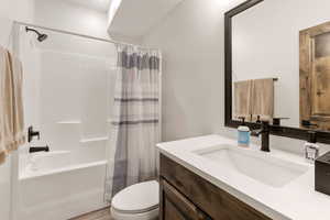 Full bath featuring vanity, shower / bath combo with shower curtain, and light wood-type flooring