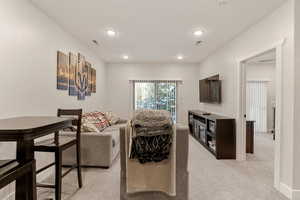 Living room featuring light carpet and recessed lighting
