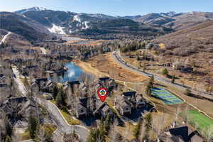 Aerial view of property's location featuring a water and mountain view