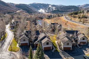 Aerial view of property's location featuring a water and mountain view