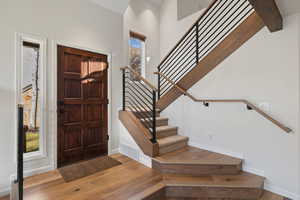 Entrance foyer with light wood-type flooring and beam ceiling