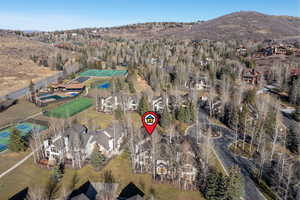Aerial view of property's location with nearby suburban area and a mountain backdrop