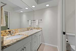 Bathroom with double vanity and recessed lighting
