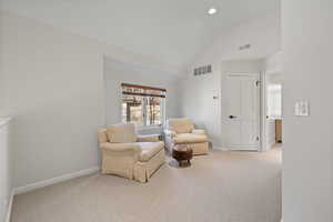 Living area featuring carpet floors, recessed lighting, and high vaulted ceiling