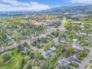 Aerial overview of property's location featuring a mountain backdrop and nearby suburban area