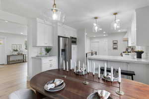 Dining space featuring light wood-style floors and recessed lighting