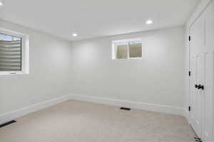 Unfurnished room featuring light colored carpet and recessed lighting