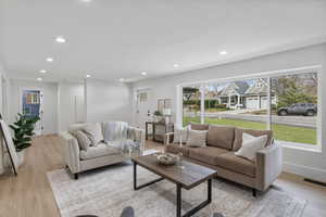 Living area featuring light wood-style floors, recessed lighting, and a textured ceiling