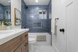 Bathroom with vanity, shower / bath combination, a textured ceiling, and recessed lighting