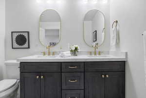 Bathroom with double vanity and toilet
