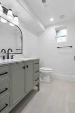 Bathroom with vanity and recessed lighting