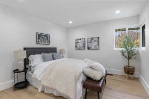 Bedroom with light wood-style floors and recessed lighting
