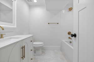 Bathroom featuring vanity, shower / washtub combination, and recessed lighting