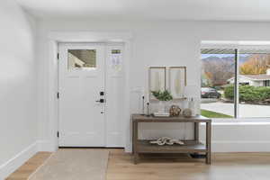 Entryway featuring light wood finished floors and plenty of natural light