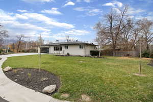 View of front of home featuring concrete driveway, brick siding, and a chimney