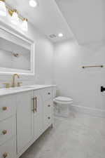 Bathroom with vanity and recessed lighting