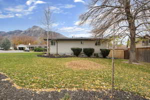 View of property exterior featuring brick siding and a mountain view