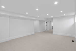 Spare room with recessed lighting and light carpet
