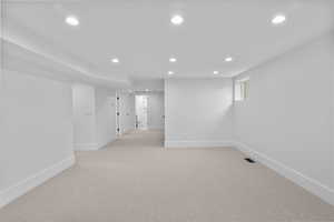 Unfurnished room featuring recessed lighting and light colored carpet