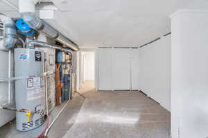 Basement featuring water heater and heating unit