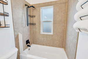 Full bath featuring bathtub / shower combination and toilet