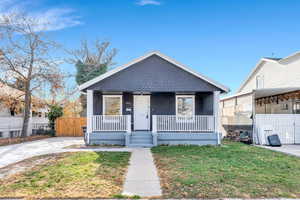 View of front of property with a porch and a gate