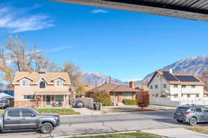 View of front of property featuring a mountain view, a residential view, and stone siding