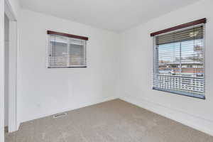 Spare room featuring carpet and baseboards