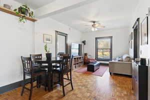 Dining room with baseboards and ceiling fan