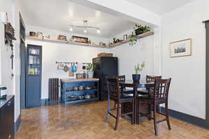 Dining space featuring radiator heating unit and baseboards