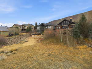 View of yard with a balcony