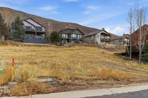 View of front of property featuring a mountain view and a balcony
