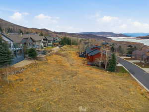 View of mountain backdrop featuring a large body of water and nearby suburban area