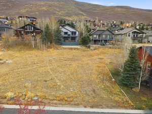 View of yard with a residential view, a mountain view, and a balcony