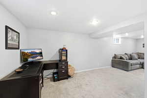 Office area with light colored carpet and recessed lighting