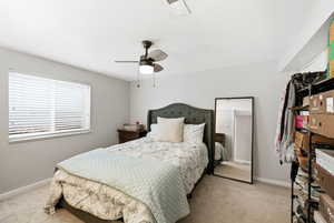 Bedroom featuring light carpet and ceiling fan