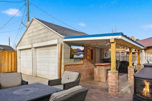 View of patio with an outbuilding and a garage