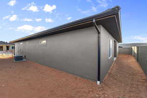 View of side of property featuring stucco siding and a fenced backyard