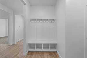 Mudroom featuring baseboards and light wood finished floors