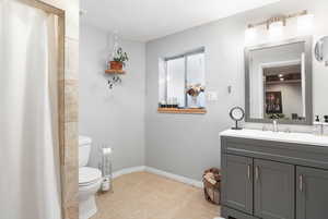 Bathroom with curtained shower and vanity