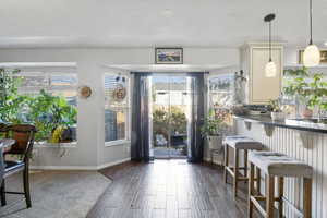 Dining area featuring wood tiled floors and baseboards