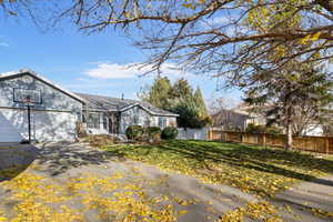 View of front of house featuring a garage and asphalt driveway