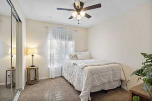 Bedroom featuring a closet, carpet, and a ceiling fan