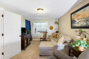 Living room featuring light carpet and baseboards