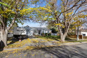 View of front of home featuring a garage and asphalt driveway