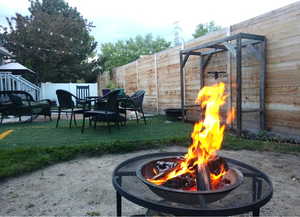 View of playground with a fenced backyard and a patio