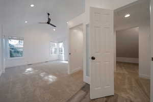 Empty room with light colored carpet, recessed lighting, a ceiling fan, and lofted ceiling