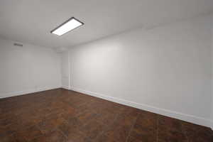 Empty room featuring baseboards